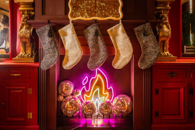 Sparkling stockings hanging above the neon fireplace at the Misfits pop-up bar in Scranton, PA.