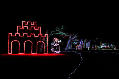 A holiday light display features a glowing Princes Peach standing next to a castle at Stone Hedge Golf Course during the Festival of Lights in Tunkhannock PA.