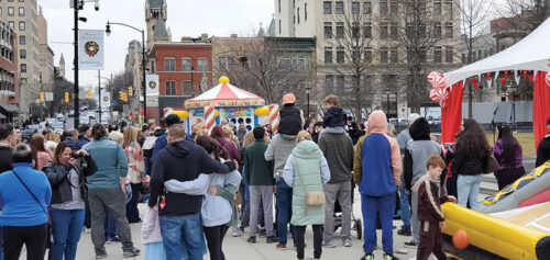 Crowds gather for family-friendly activities during Downtown on Ice in Scranton, PA, as visitors explore winter attractions and entertainment throughout downtown.