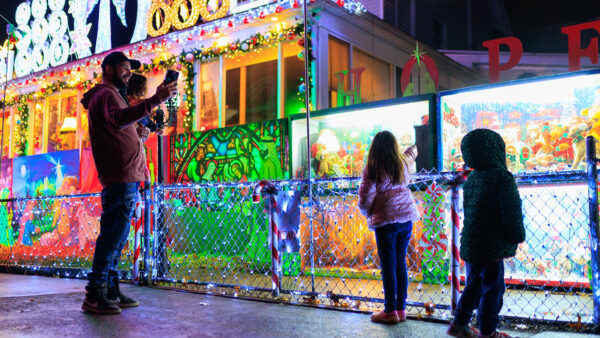 A family poses for a photo outside a popular Christmas lights display in Scranton, PA.