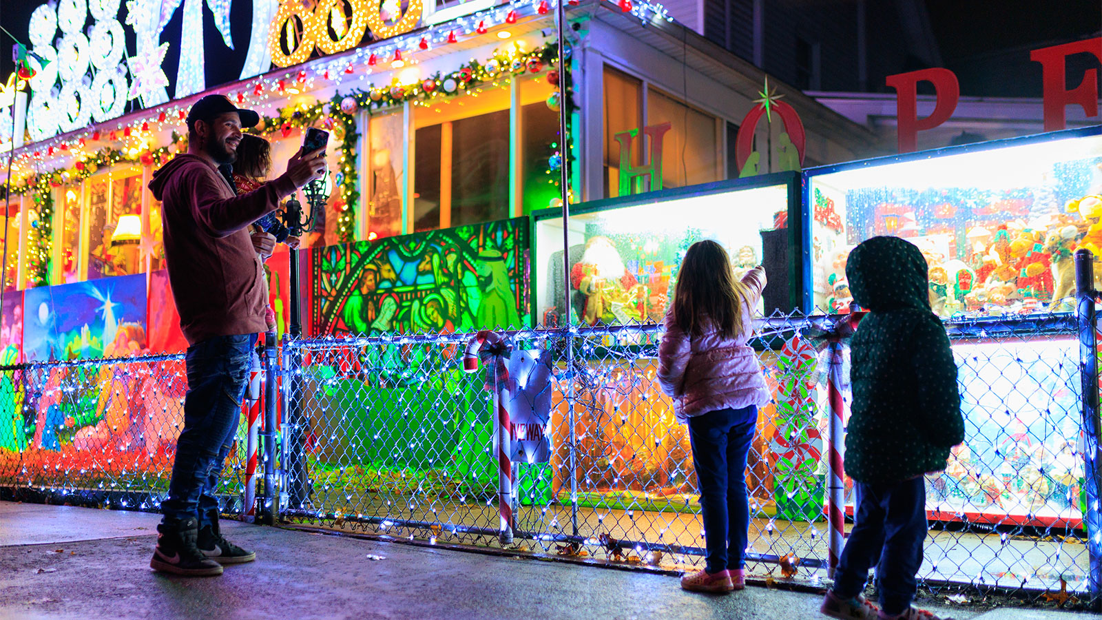 A family poses for a photo outside a popular Christmas lights display in Scranton, PA.