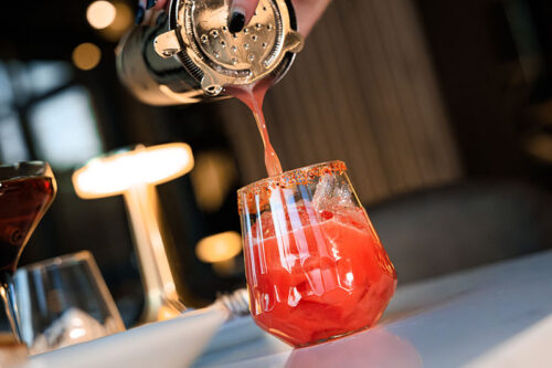 A vibrant red beverage being poured into a rimmed glass at A'tera 519 in Scranton, PA