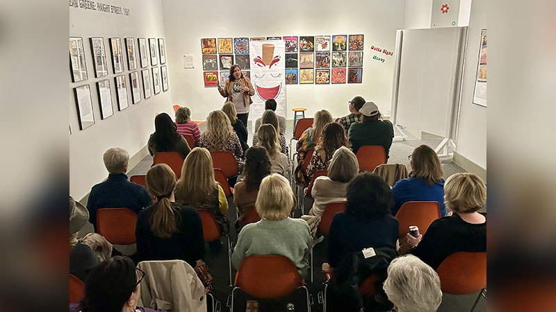 A woman speaks to an audience seated in one of the galleries at the Everhart Museum in Scranton, PA.