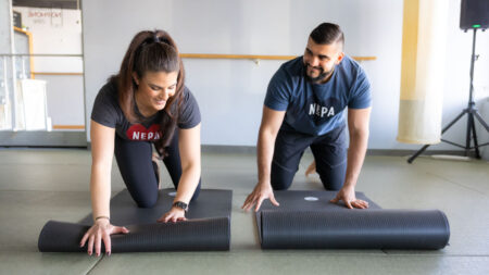 Image of man and woman unrolling yoga mats at Melt Hot Yoga in Wilkes-Barre, PA