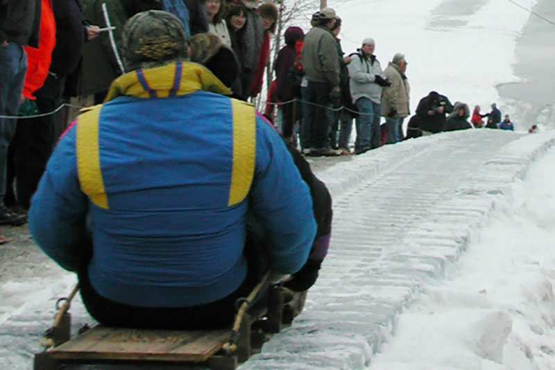 Man sliding down The Eagles Mere Toboggan Slide in Eagles Mere, PA.