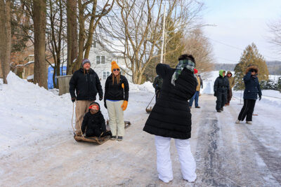 A family of three pose for a photo at the Eagles Mere toboggan slide in Eagles Mere, PA.