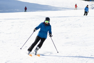 Image taken from the bottom of hill looking up at skiers coming down the mountain at Elk Mountain in Union Dale, PA.