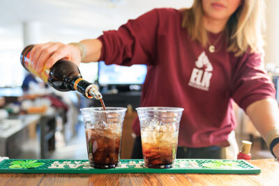 Close up image of bartender pouring cocktails into two cups inside the Winter Garden restaurant at Elk Mountain in Union Dale, PA.
