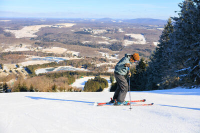 Image of man standing on top of the mountain just before going down the headwall at Elk Mountain in Union Dale, PA.