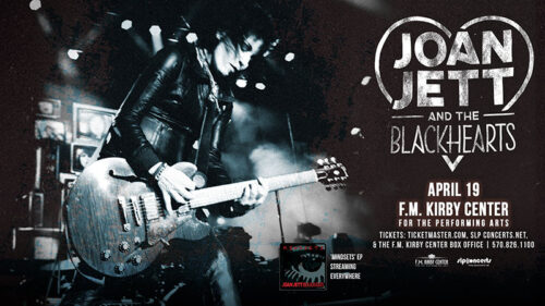 Joan Jett playing the guitar on a promotional poster for Joan Jett and the Blackhearts at the F.M. Kirby Center in Wilkes-Barre, PA.