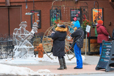 A group of people taking photos of ice sculptures during Winterfest in Jim Thorpe, PA