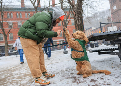 A man gives his dog a treat during Winterfest in Jim Thorpe, PA