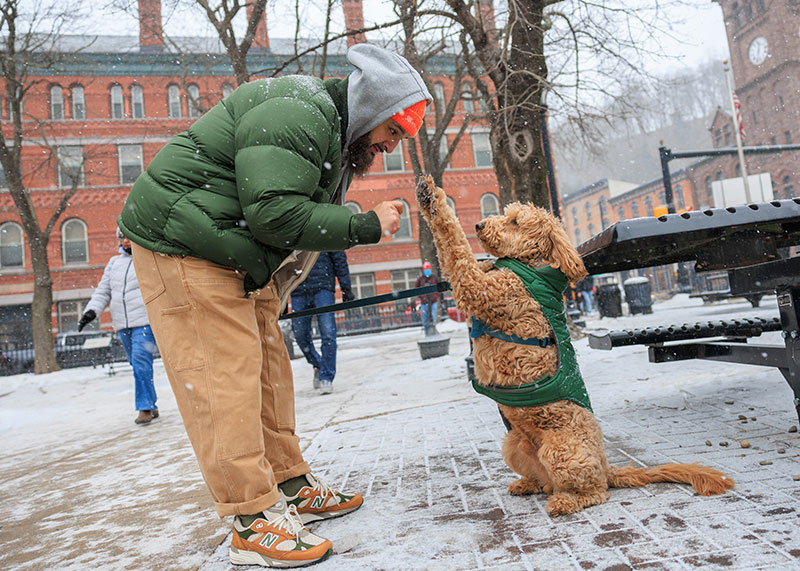 A man gives his dog a treat during Winterfest in Jim Thorpe, PA