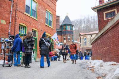 A group of people walking down Race Street during Winterfest in Jim Thorpe, PA