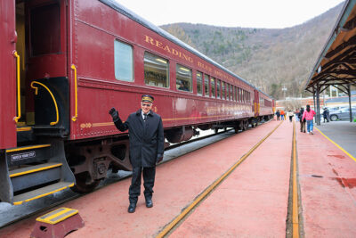 A train conductor waves to the camera during Winterfest in Jim Thorpe, PA