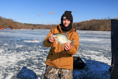 A man holds a crappie during Nanticoke Conservation Club's Ice Fishing Derby at Frances Slocum State Park in Wyoming, PA.