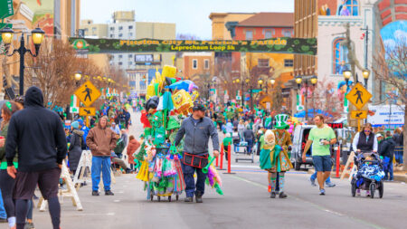 A street vendor walks down the street at the Pittston St. Patrick's Day Parade in Pittston, PA.
