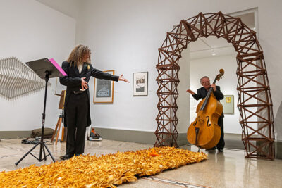 A music conductor and standup bass player applaud each other at the Everhart Museum in Scranton, PA.