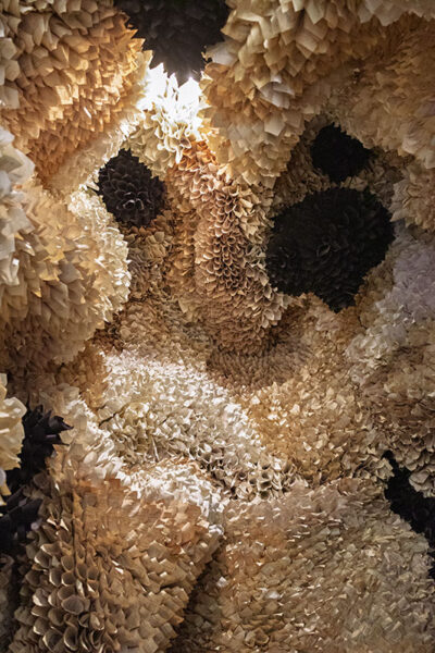 The interior of a cavernous artwork display that is made entirely of rolled up pages from a book at the Everhart Museum in Scranton, PA.