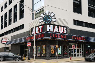 The exterior of the Scranton Art Haus building which is white on the top with dark colored stone on the bottom. and has the words 