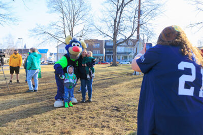 A family poses with Champ, the Scranton/Wilkes-Barre RailRiders mascot, at the second annual St. Patrick's Day Parade in Nanticoke, PA.