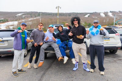 A group of men, tailgating, pose for the camera at Camelback Resort's 20th Pond Skim event in Tannersville, PA.
