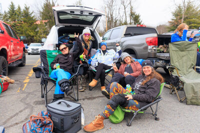 A group of women, tailgating, pose for the camera at Camelback Resort's 20th Pond Skim Event in Tannersville, PA.