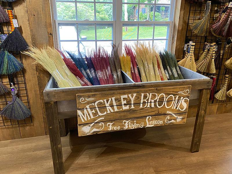 A reclaimed sink basin holds colorful, handmade dyed corn brooms at Meckley Brooms in Lopez, PA.