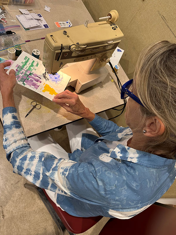 A woman creates artwork using a sewing machine at the David A. DeWire Center in Eagles Mere, PA.