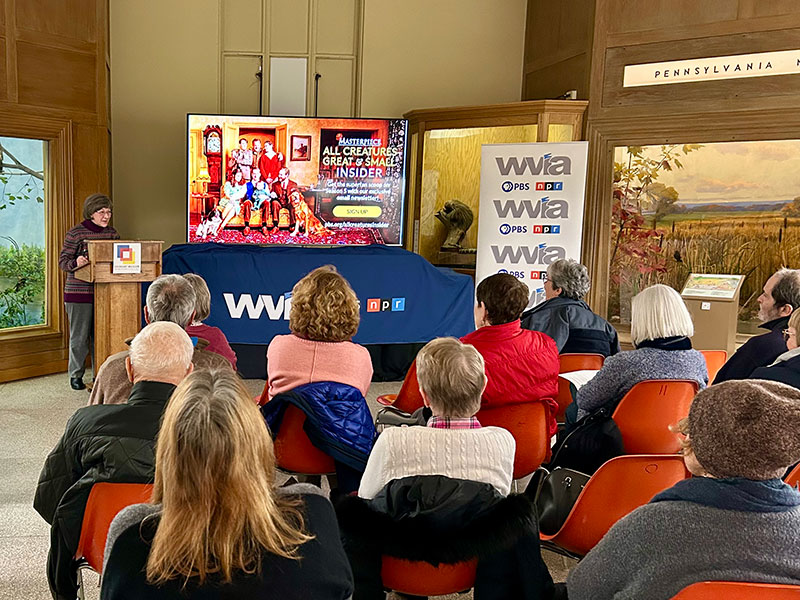 A group of attendees sits in chairs and listens to a presentation at the Everhart Museum in Scranton, PA.