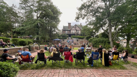 Attendees gather on the lawn in sport chairs while listening to a band at Schuylkill County Brewfest in Pottsville, PA.