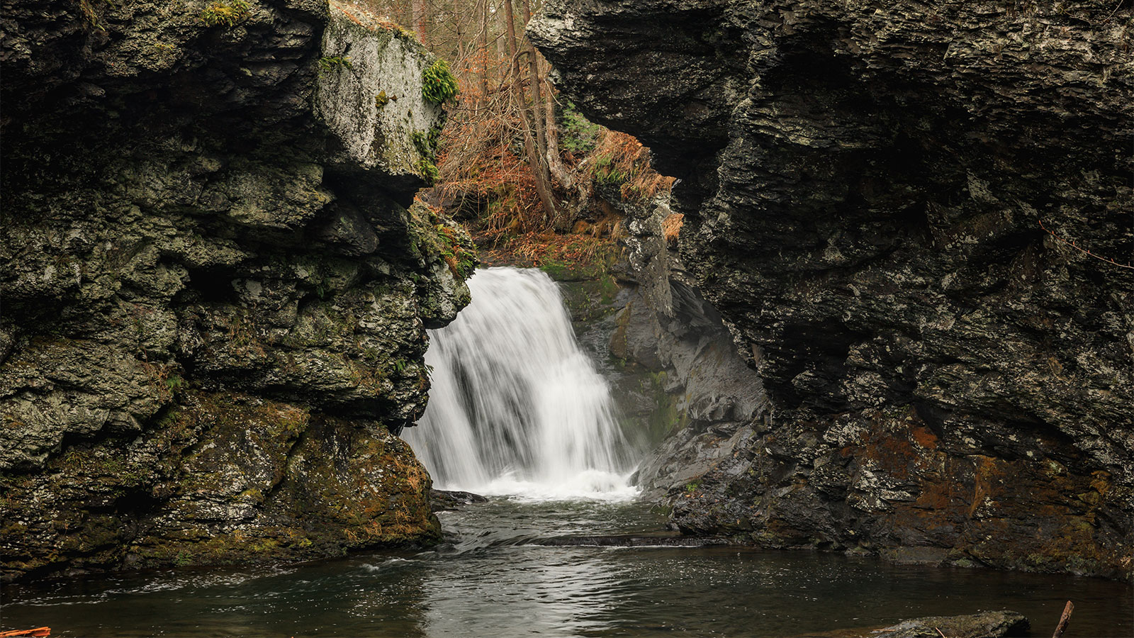A waterfall splashes between two large rock outcroppings at Marshalls Falls Park in East Stroudsburg, PA.
