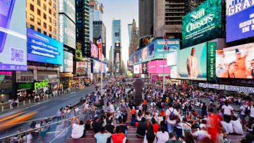 The busy street, bright billboards, and skyscrapers in Times Square in New York City.
