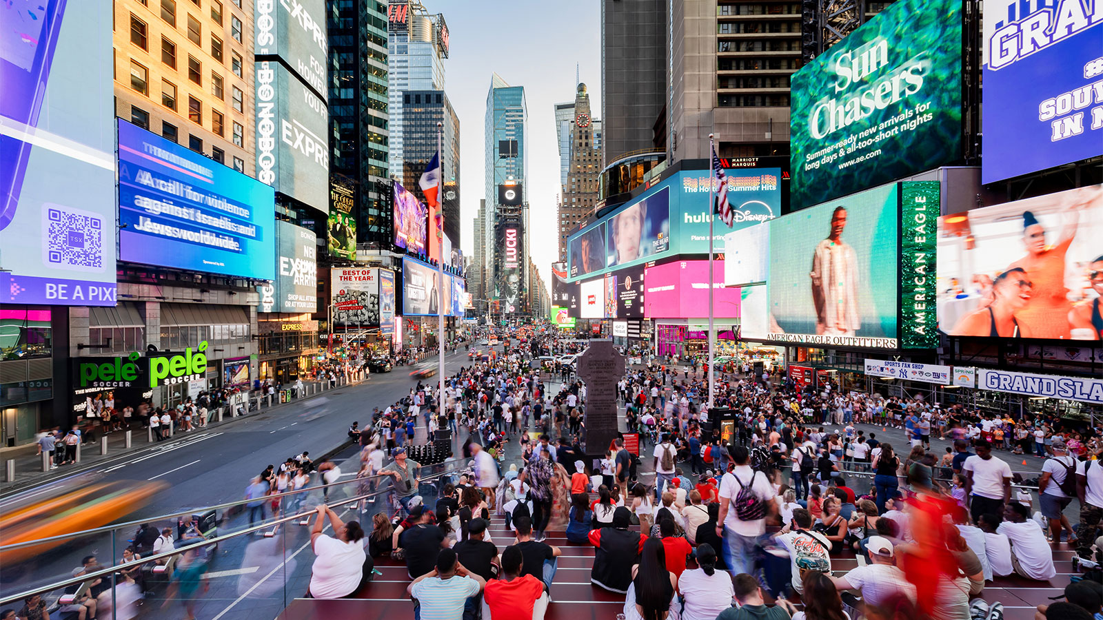 The busy street, bright billboards, and skyscrapers in Times Square in New York City.