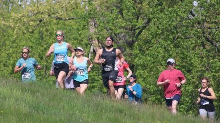 Runners wearing race bibs take part in the Wyoming Valley Striders' Cherry Blossom 5-Mile Run at Kirby Park in Wilkes-Barre, PA.