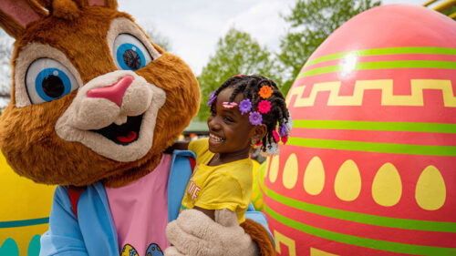 A girl with her arm around a large bunny character at Dutch Wonderland in New Jersey.