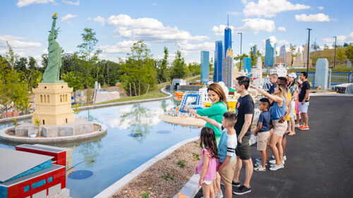People looking at the pond at Legoland New York Resort in Goshen, NY.