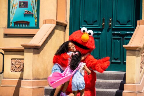 Children hugging Elmo at Sesame Place in Philadelphia, PA.
