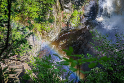 A rainbow shining over one of the 8 waterfalls at Bushkill Falls in Bushkill, PA.