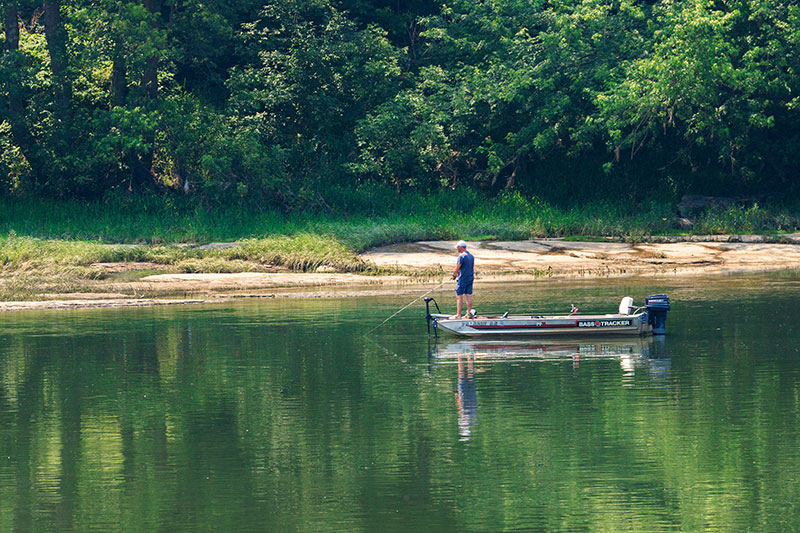 A fisherman casts a line from the bow of a fishing boat on the Susquehanna River in Tunkhannock.
