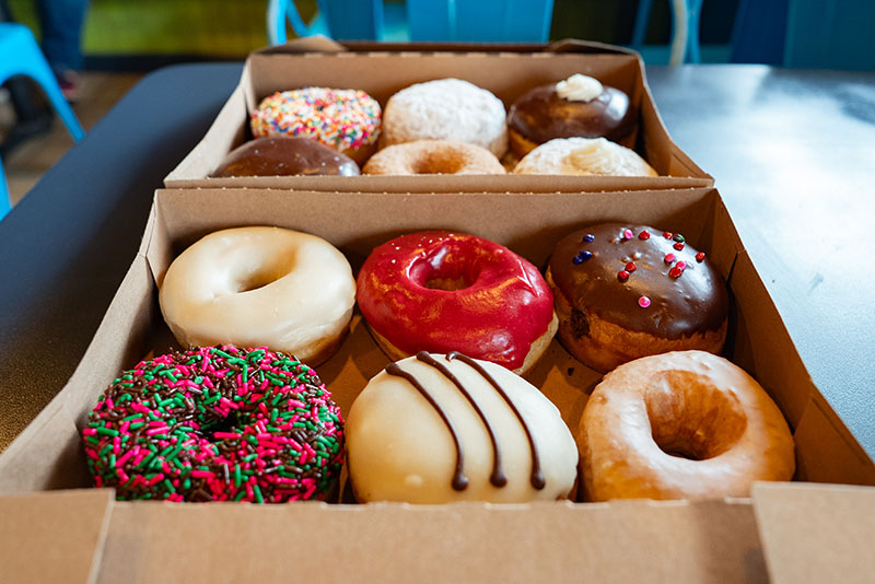 Two boxes of colorfully decorated donuts from Dough Monster in Berwick, PA.
