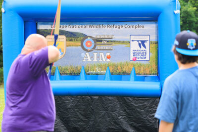 A man draws back a bow during the 2025 River of the Year celebration at Minisink Park in East Stroudsburg, PA.