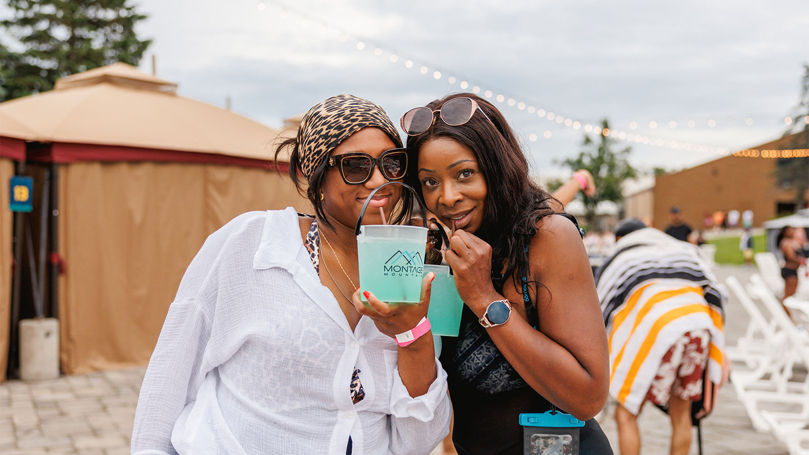 Two Women enjoying drinks pool side at Adult Night at Montage Mountain Waterpark in Scranton, PA.