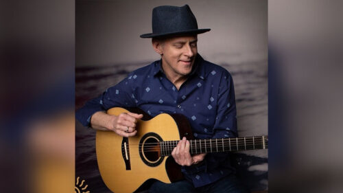Willy Porter holds a guitar in a promotional photo for his stop at Mauch Chunk Opera House in Jim Thorpe, PA.
