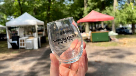 A hand holds a glass from the Schuylkill County Wine Festival held at Hegins Park in Hegins, PA.