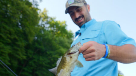 A fisherman poses with his catch on the Susquehanna River with 2 Fist Guide Service in Tunkhannock, PA.