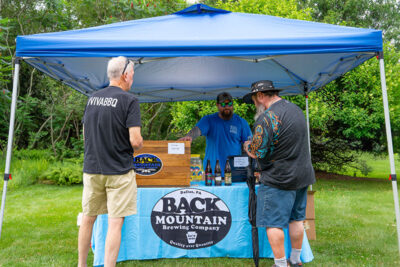 Visitors getting beer samples at a tent for Back Mountain Brewing Company
