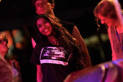 A woman smiles while watching a band perform at the Briggs Farm Blues Festival in Nescopeck, PA.