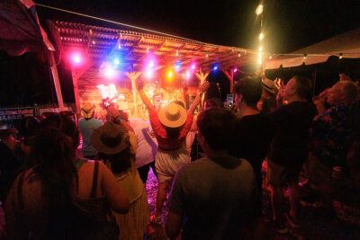A lively crowd cheers for a band at the Briggs Farm Blues Festival in Nescopeck, PA.