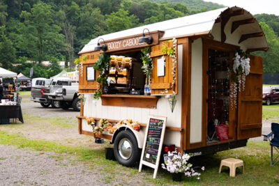 A trailer named the Boozy Caboose parked at a Food Truck Festival at the Garden Drive-In Theater